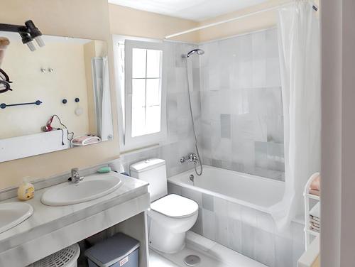 a bathroom with a sink and a toilet and a shower at Elegant Villa in Nuevo Portil with Shared Pool in El Portil