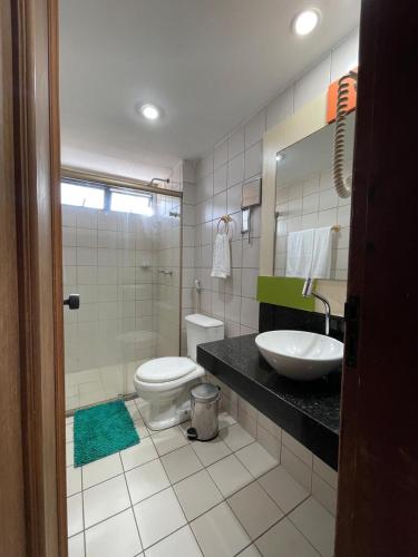 a bathroom with a toilet and a sink at Flat Mont Blanc - Perto de Tudo! in São Luís