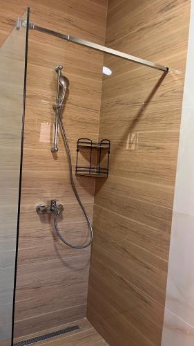 a shower with a hose attached to a wooden wall at House Baltic KAMENO Herceg Novi in Herceg-Novi