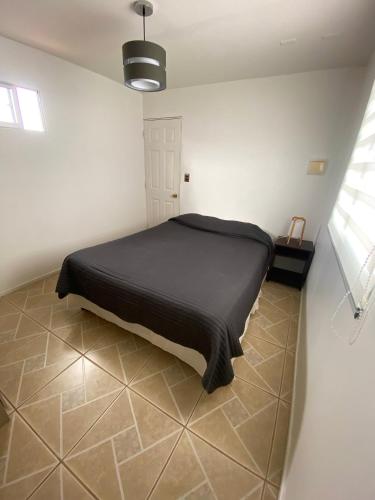 Ένα ή περισσότερα κρεβάτια σε δωμάτιο στο Casa acogedora dentro de parcela cerca de la playa