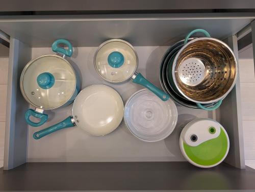 a bunch of pots and pans hanging on a shelf at Modern 2 bedroom condo with AC in Olympic Village in Vancouver