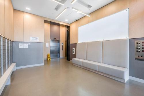 an empty hallway with a large screen in a building at Modern 2 bedroom condo with AC in Olympic Village in Vancouver