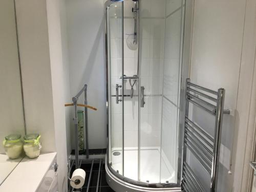a glass shower in a bathroom with a toilet at SleepNeat in Ascot