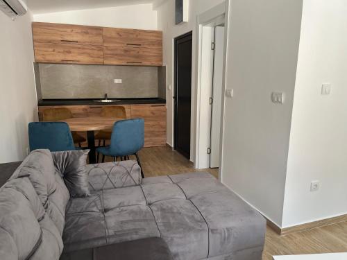 a living room with a couch and a table at HARIZMA LUX Banja Vrujci in Popadić