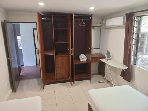 a living room with a closet and a desk at Dreamview Villas in Rakiraki