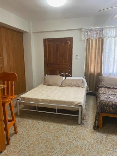a bedroom with a bed and a chair in it at DS Palancas Lodging Home in Candelaria