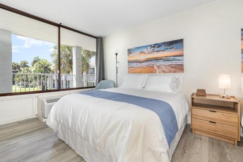 a bedroom with a bed and a large window at Charming Suite: Smart TV, Modern Amenities & Pool Access in Kissimmee