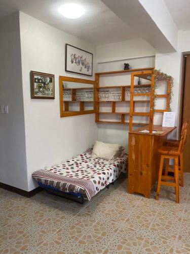 a bedroom with bunk beds and a desk and a bed at DS Palancas Lodging Home in Candelaria