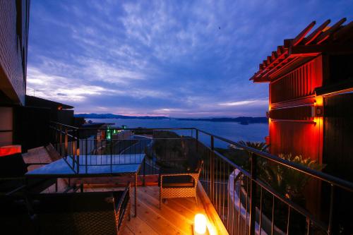 a balcony with a table and chairs on a building at Plaza Awajishima in Minamiawaji
