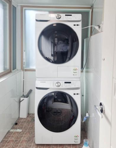 two washing machines stacked on top of each other at Busan Circle Stay Hotel in Busan