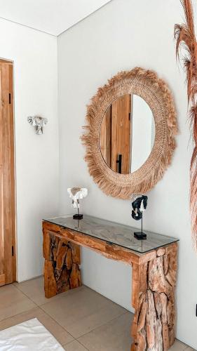a mirror sitting on top of a table in a room at Villa Elior Selong Belanak, South Lombok in Selong Belanak