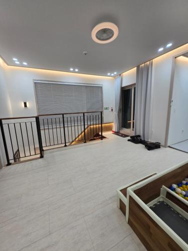 a large room with a balcony with a large window at Daori Pension in Boryeong