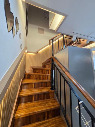 a staircase in a building with wooden stairs at Daori Pension in Boryeong