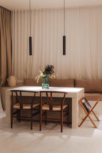 a living room with a table and a couch at Sore Escape Tumbak Bayuh by Betterplace in Tumbak Bayuh