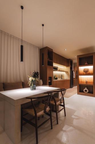 a kitchen with a table and chairs in a room at Sore Escape Tumbak Bayuh by Betterplace in Tumbak Bayuh