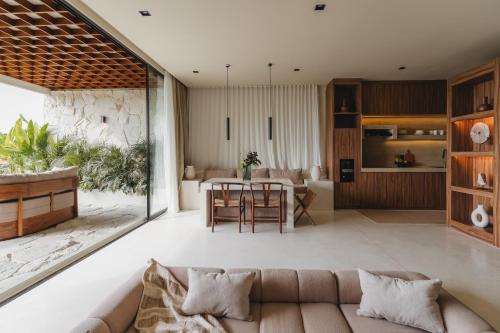 a living room with a couch and a table at Sore Escape Tumbak Bayuh by Betterplace in Tumbak Bayuh