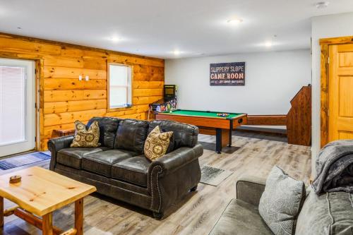 a living room with a leather couch and a pool table at Slippery Slope Cabin at Deep Creek Lake / Wisp Mountain (3 BR) in McHenry