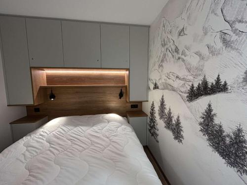 une chambre avec un lit avec un tableau sur le mur dans l'établissement Appartement moderne, proche pistes, 4 pers, Wi-Fi, linge inclus - FR-1-180-650, à Les Allues
