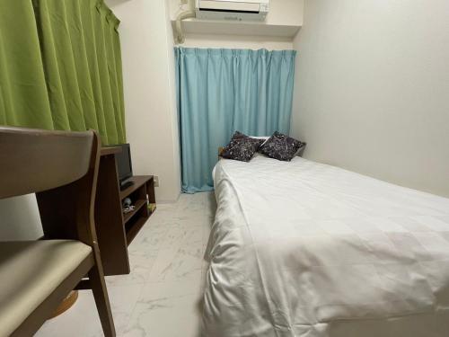 Ένα ή περισσότερα κρεβάτια σε δωμάτιο στο A&C STAY Shin-Osaka