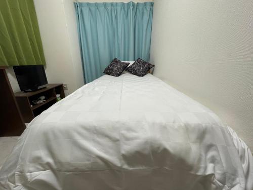 Ένα ή περισσότερα κρεβάτια σε δωμάτιο στο A&C STAY Shin-Osaka