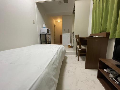 Ένα ή περισσότερα κρεβάτια σε δωμάτιο στο A&C STAY Shin-Osaka