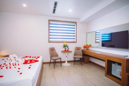 a bedroom with a bed and a desk and a tv at Crystal Holiday Hotel Ha long - 3 Loc Vung Street in Ha Long