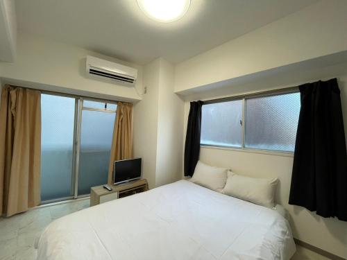 Ένα ή περισσότερα κρεβάτια σε δωμάτιο στο A&C STAY Shin-Osaka