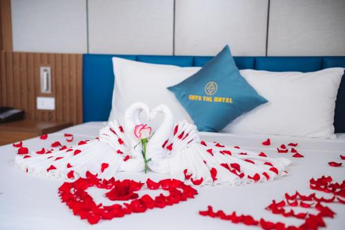 a bed with a bunch of red roses on it at Crystal Holiday Hotel Ha long - 3 Loc Vung Street in Ha Long