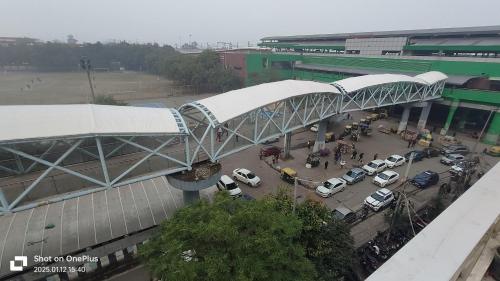 a parking lot with cars parked in front of a building at Hotel Moon Chanakyapuri Satya Niketan- Couple Friendly in New Delhi
