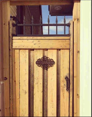 a wooden door with a metal latch on it at West House Private Garden Suite with Skylight in Brampton