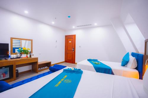a hotel room with two beds and a tv at Crystal Holiday Hotel Ha long - 3 Loc Vung Street in Ha Long