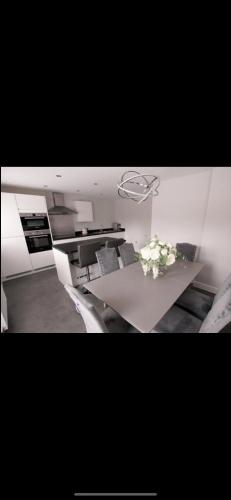 a room with a table with a vase of flowers on it at 3 Bedroom Beautiful Home with Garden, AC, Hot Tub in Portsmouth