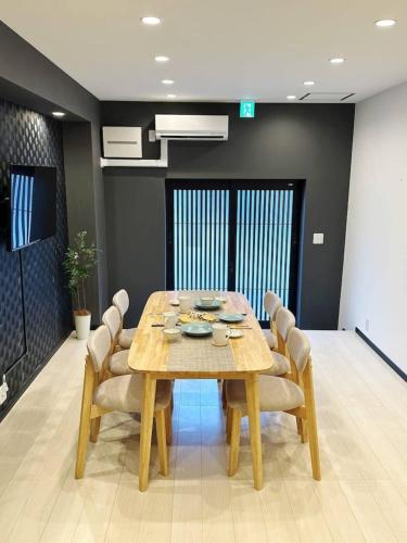 a dining room with a wooden table and chairs at 福源阁-日式别墅-整栋独享-新深江站步行5分-90平方6人入住-难波心斋桥直达8分-3室两卫-洗烘一体机 in Osaka