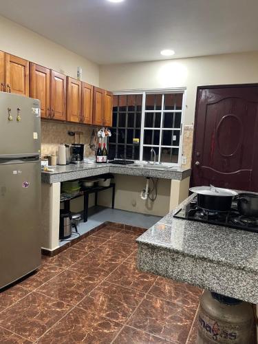a kitchen with a refrigerator and a counter top at apartamento hacia las olas Playa la Barqueta in Querévalo