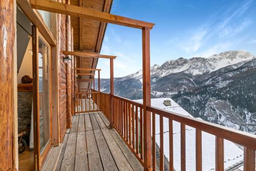 a balcony with a view of snow covered mountains at Gleise Lodge apartment - Happy Rentals in Bardonecchia