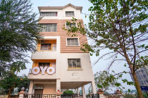 a building with a sign on the side of it at Hotel O Urban Village Guest House in Kolkata