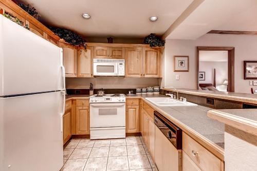 a kitchen with white appliances and wooden cabinets at St. James Place in Beaver Creek