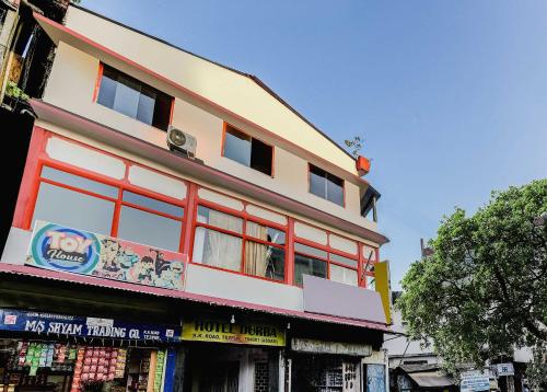 a building with red windows on the side of it at SPOT ON Durba 2 in Tezpur