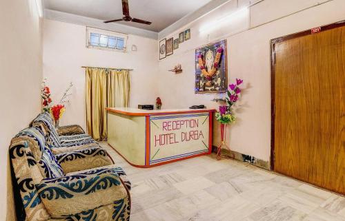 a living room with two chairs and a reception desk at SPOT ON Durba 2 in Tezpur