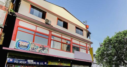 a building with red windows on the side of it at SPOT ON Durba 2 in Tezpur