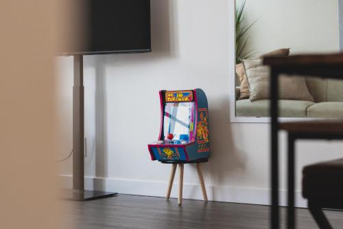 a pinball machine sitting on a stand in a room at Chez Alphonse in Seattle