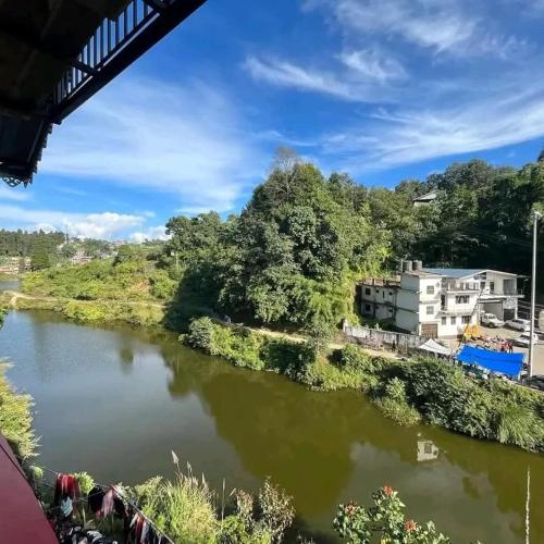 a view of a river from a bridge at Lake Side Homestay - Pradhan Homestay Mirik in Mirik