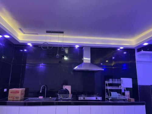 a kitchen with black walls and a ceiling with lights at Shiri Hotel Pool Villa 3 쉬리호텔 풀빌라 3 in Lalaan Primero