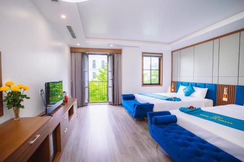 a hotel room with two beds and a tv at Crystal Holiday Hotel Ha long - 3 Loc Vung Street in Ha Long