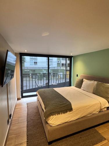 a bedroom with a large bed and a large window at Departamento en Ciudad de México in Mexico City