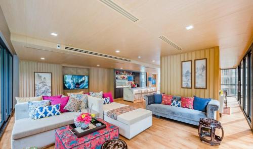 a living room with two couches and a table at The Base Central Phuket-C54BS in Phuket Town
