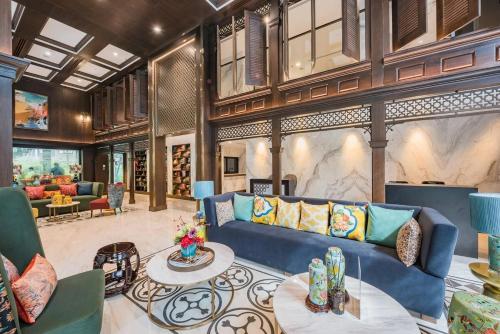 a living room with a blue couch and a table at The Base Central Phuket-C54BS in Phuket Town