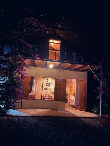 a building with a balcony on top of it at night at Mộc Lan’s House in Phi Liêng