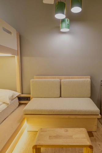 a couch in a room with a bed and a table at Rest Chinatown Hotel in Singapore
