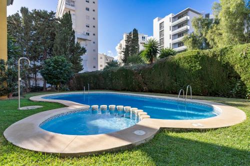 a swimming pool in the yard of a building at Penthouse - Beach - Sea View - Pool - 40 sqm Private Terrace - One Bedroom - Sleeping Alcove in Benalmádena